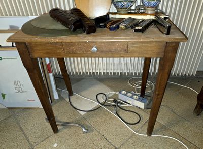 a wooden table with a hat on top of it
