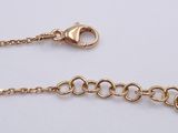 a close up of a gold chain on a white background
