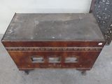 an old wooden cabinet with a metal top