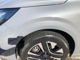 a close up of a car ' s tire on the side of the road