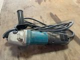a small electric drill on a table with a cord