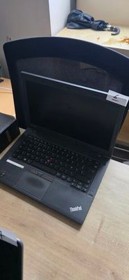 two laptops sitting on a desk next to each other