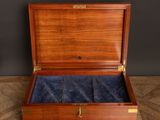an open wooden box with a blue velvet lining inside