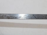 a close up of a piece of metal with writing on it