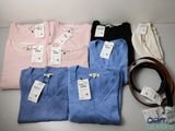several shirts and a belt are sitting on a table