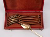 silverware in a red case with a spoon and spoon rest