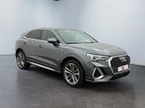 a grey audi qx parked in a showroom