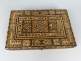 an old wooden box with a decorative design on it