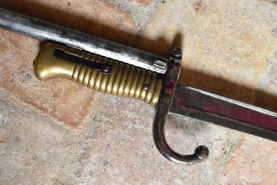 a close up of a sword on a tile floor