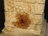 a close up of a stone wall with a brown stain on it
