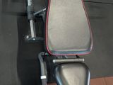 a black and red bench in a gym room