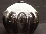 an image of a black and white vase on a table