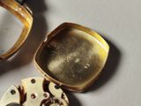 a close up of a watch and a watch case