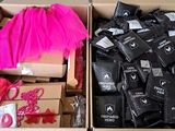 two boxes filled with different types of clothing and a pink tutu