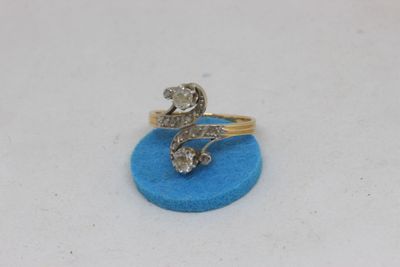 a close up of a diamond ring on a blue surface