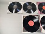 three black vinyl records sitting on top of a table next to each other