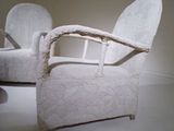 a white chair that is sitting in the middle of a room