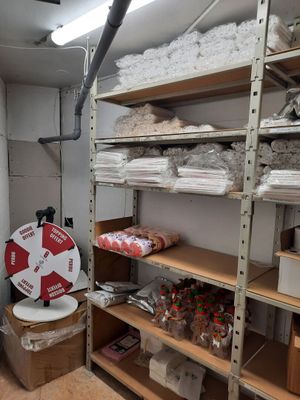 a room with a lot of shelves and boxes on it