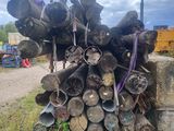 a pile of logs sitting on the side of the road