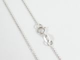 a close up of a chain on a table with a white background