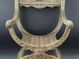 an antique wooden chair with ornate carvings on the back of it