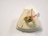 a gold ring with a blue stone on top of a piece of paper