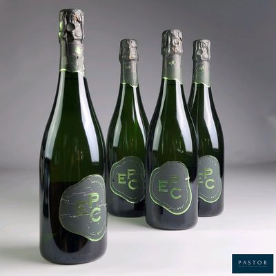 three bottles of champagne with a green label and a white background