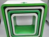 three green and white nesting boxes stacked on top of each other