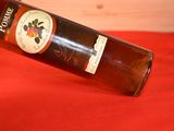 a bottle of wine sitting on a red table cloth