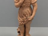 two statues of a boy and a girl on a pedestal