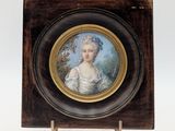 an old picture of a woman in a white dress in a wooden frame