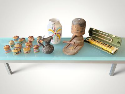 a blue table with a piano, vases, and other items on it