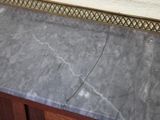 a marble counter top with a mirror above it