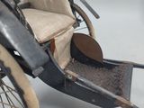 an old fashioned carriage with a seat on it