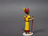 toy figurine of a woman in a yellow dress with a red hat and a cane