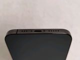 the back of a black iphone with a small screen on a white surface
