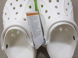 a pair of white crocs that are on a table