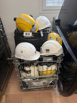 a basket full of hard hats and other safety gear