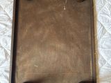 a metal tray on a bed with a white sheet