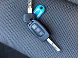 a car key and a remote control on the seat of a car