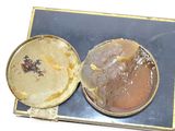 two tins with food in them sitting on a table