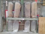 many rolls of fabric sitting on a shelf in a warehouse