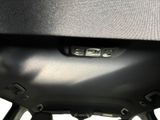 a close up of a car door handle with a button on it