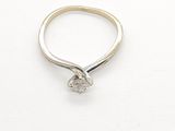 a picture of a diamond ring on a white surface