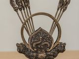 an image of a metal sculpture of arrows and a shield