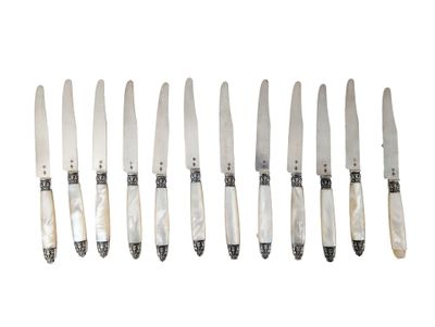 six knives are lined up in a row on a white surface