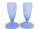two blue vases sitting on a white surface