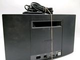 a black cd player with a cord on top of it