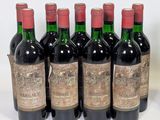 six bottles of wine are lined up in a row on a white surface