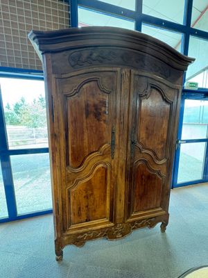 une grande armoire en bois au milieu d'une pièce